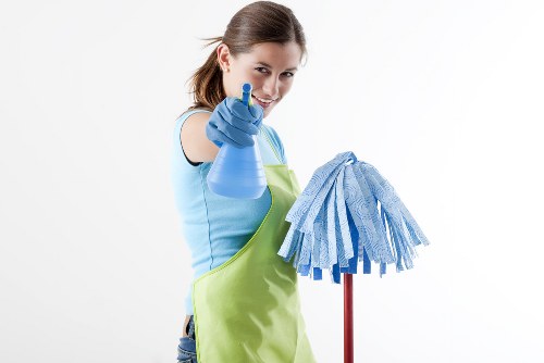 Person vacuuming a mattress during cleaning