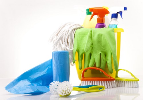 Cleaning staff maintaining a shared office workspace