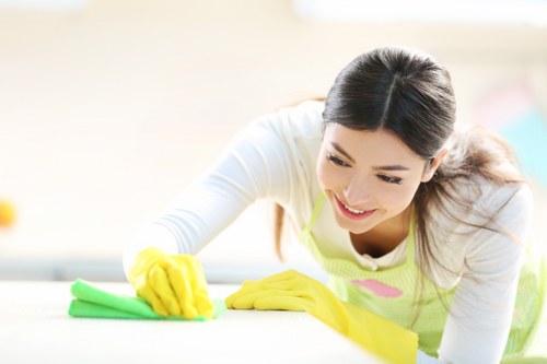 Cleaner mopping corridor floor in a shared property